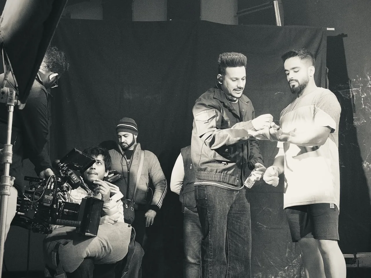 A run-through on a black-draped set, the camera rolling in the corner