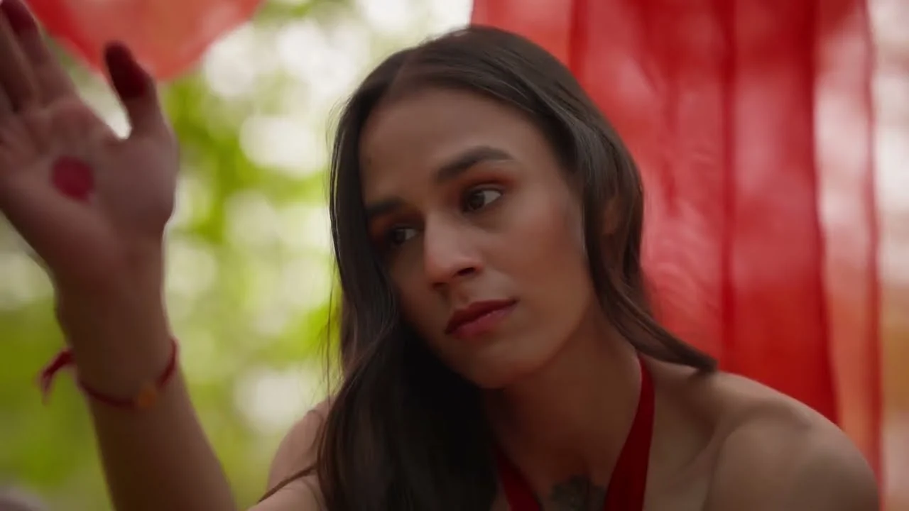 Close-up, hand raised against a red backdrop