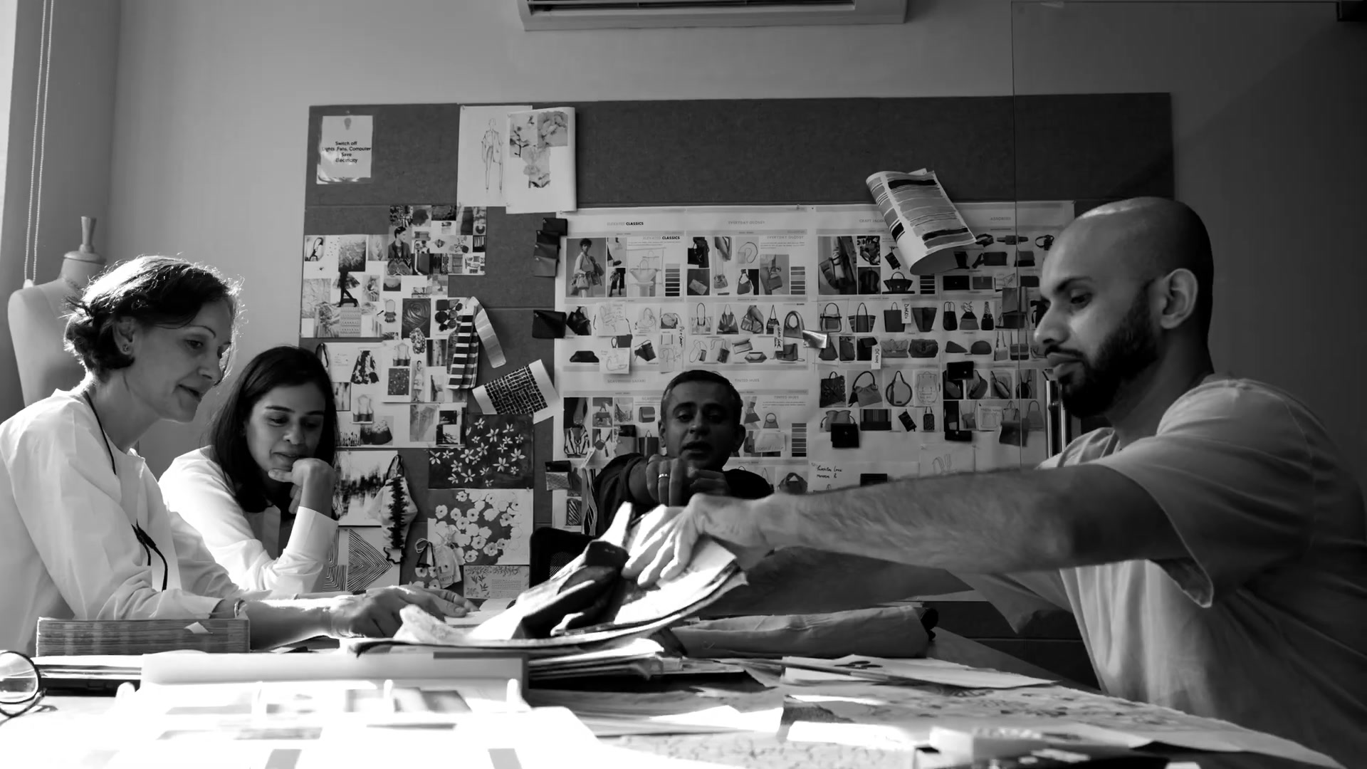 Design team around the worktable (black and white)