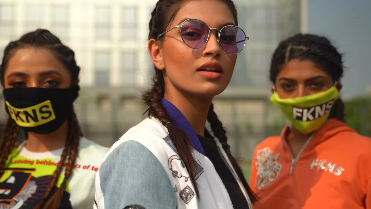 Three models in streetwear and masks