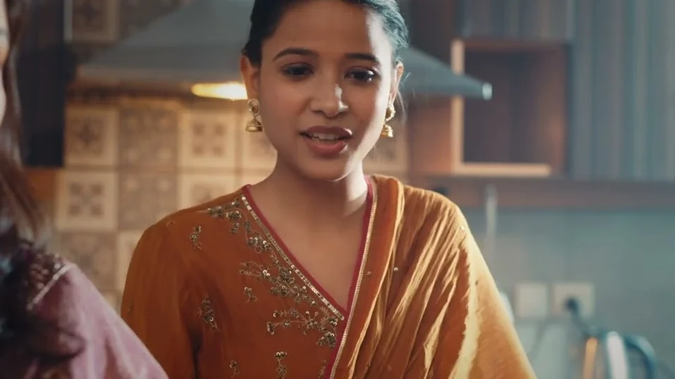 A woman in an orange saree