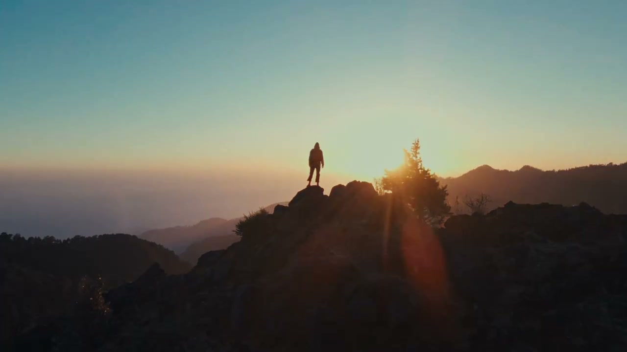 Lone figure on the ridge at sunrise