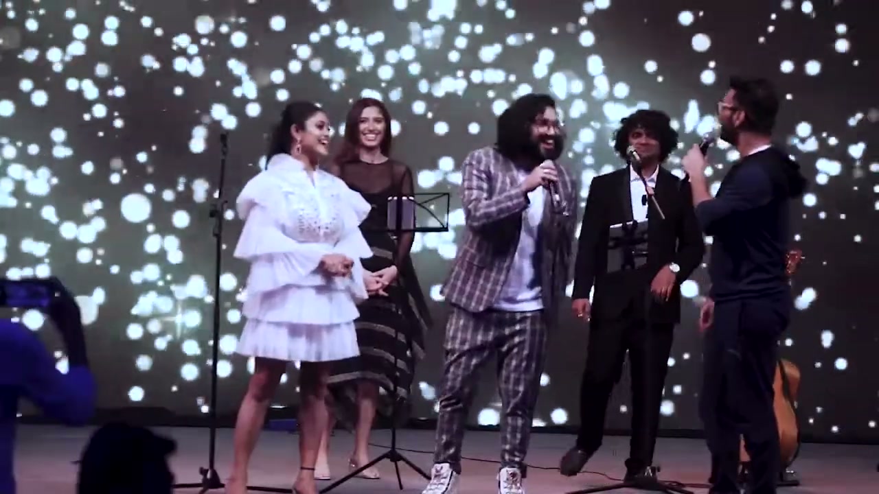 Performers on stage against a starfield screen